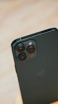 Detailed close-up of a smartphone with a triple camera lens, showcasing advanced photography features.