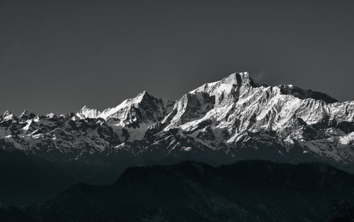 Free Panoramic view of the majestic snow-covered Himalayas in Uttarakhand, India, captured at sunrise. Stock Photo