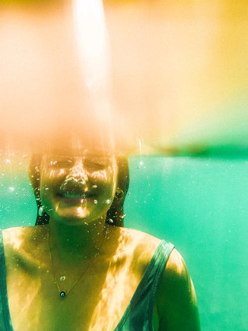 Photo of a Smiling Woman Underwater