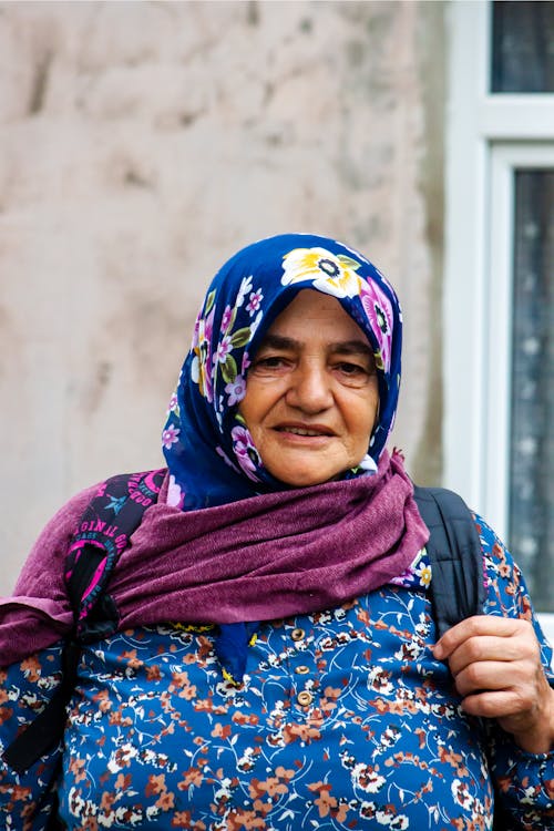 Elderly Woman in Blue Floral Hijab