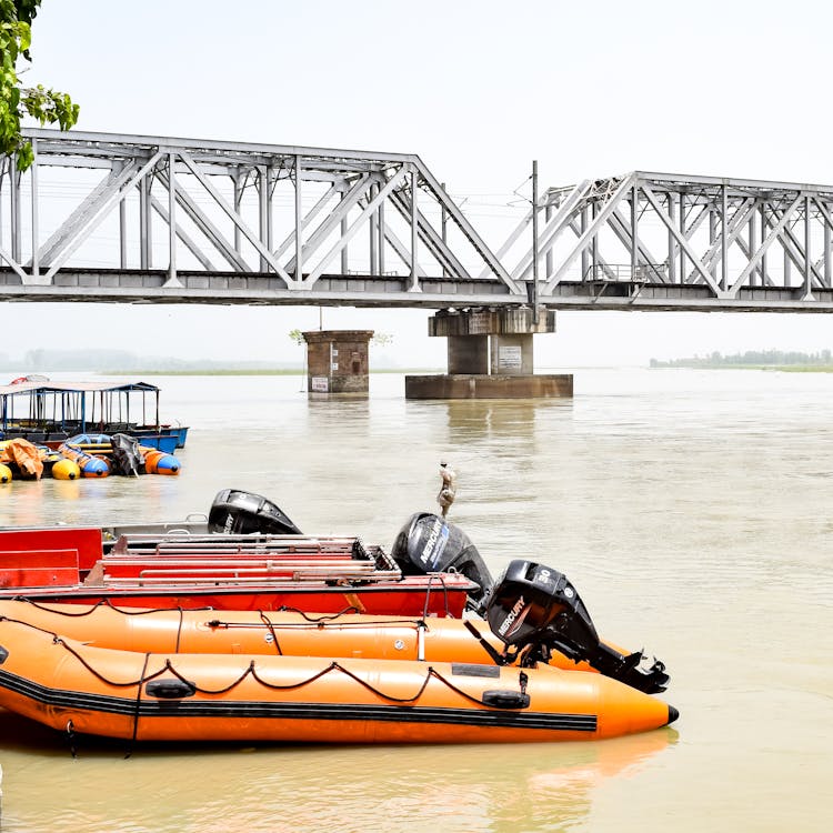 High Tide And Boats Moored By A Bridge