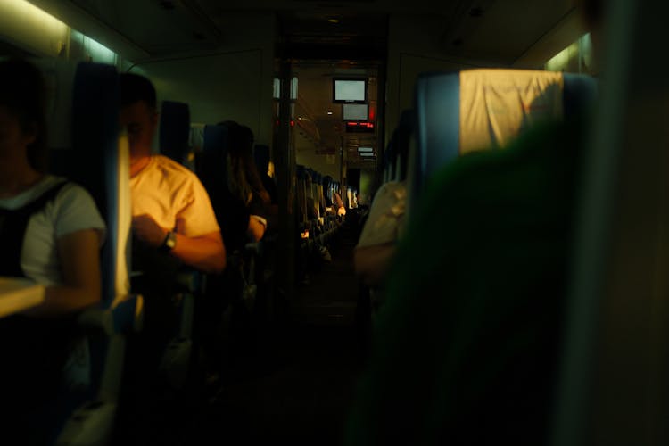 Passengers Sitting In Airplane