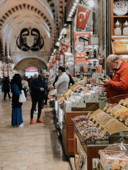 A bustling Turkish market with diverse merchandise and shoppers engaging with merchants in a lively atmosphere.