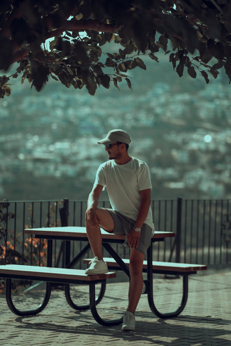 Man Sitting On Outdoor Table