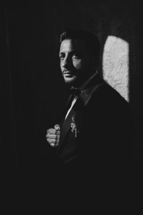 Free High contrast black and white portrait highlighting a man in a suit, exuding mystery. Stock Photo