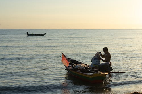 A Fisherman Boarding a Boat