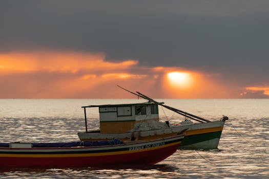 Vibrant fishing boats against a breathtaking coastal sunrise scenery.