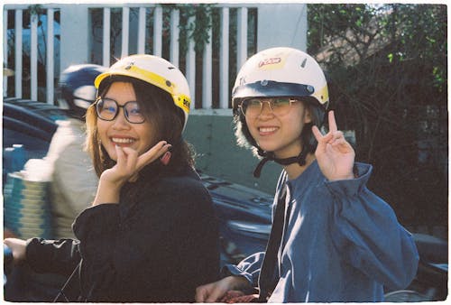Women in Black and Blue Jacket Wearing Helmets