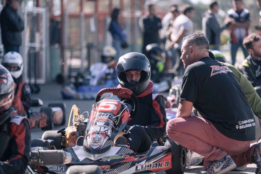 Man in Black Shirt Riding on Red and Blue Go Kart