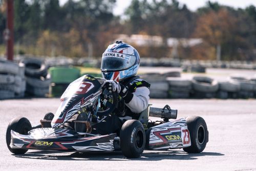Free A go-kart racer in action on a sunny day at the race track, showcasing speed and skill. Stock Photo