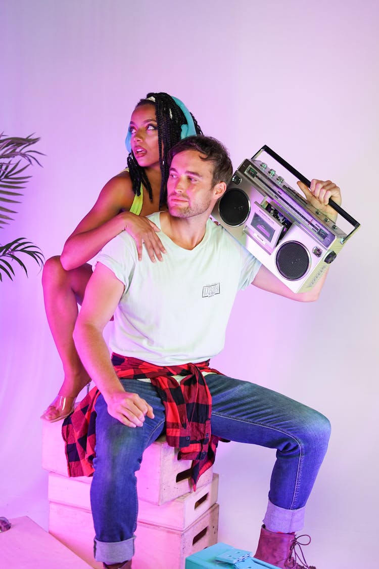 Photo Of A Woman And A Man Posing With A Boombox