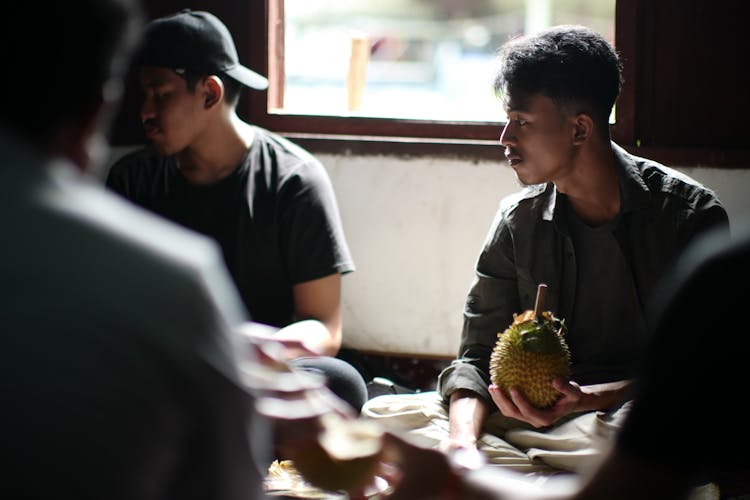 Man Holding Durian Fruit