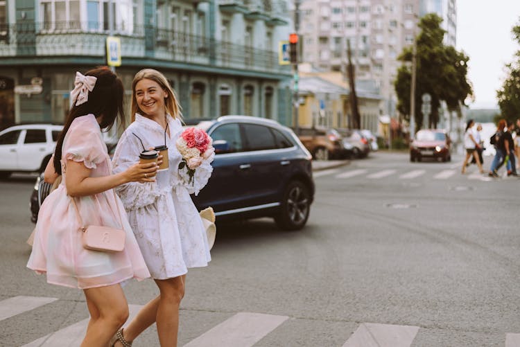 Smiling Girls In Fancy Dresses Walking On Street