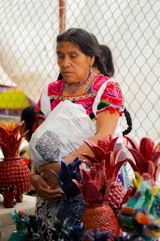 A woman in traditional attire selling crafts at a Mexican market, showcasing cultural heritage.