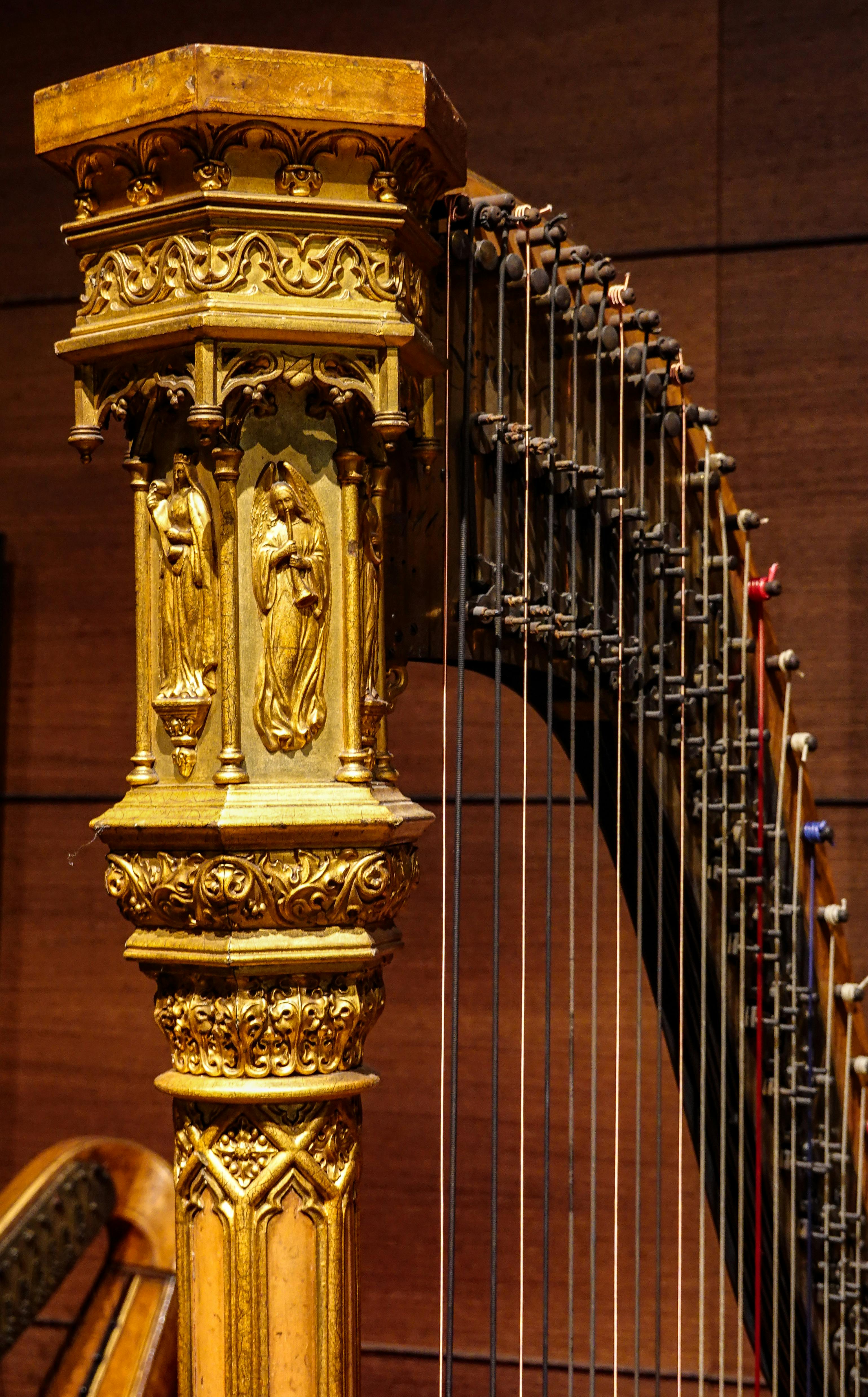 close up of a harp with gold carved details