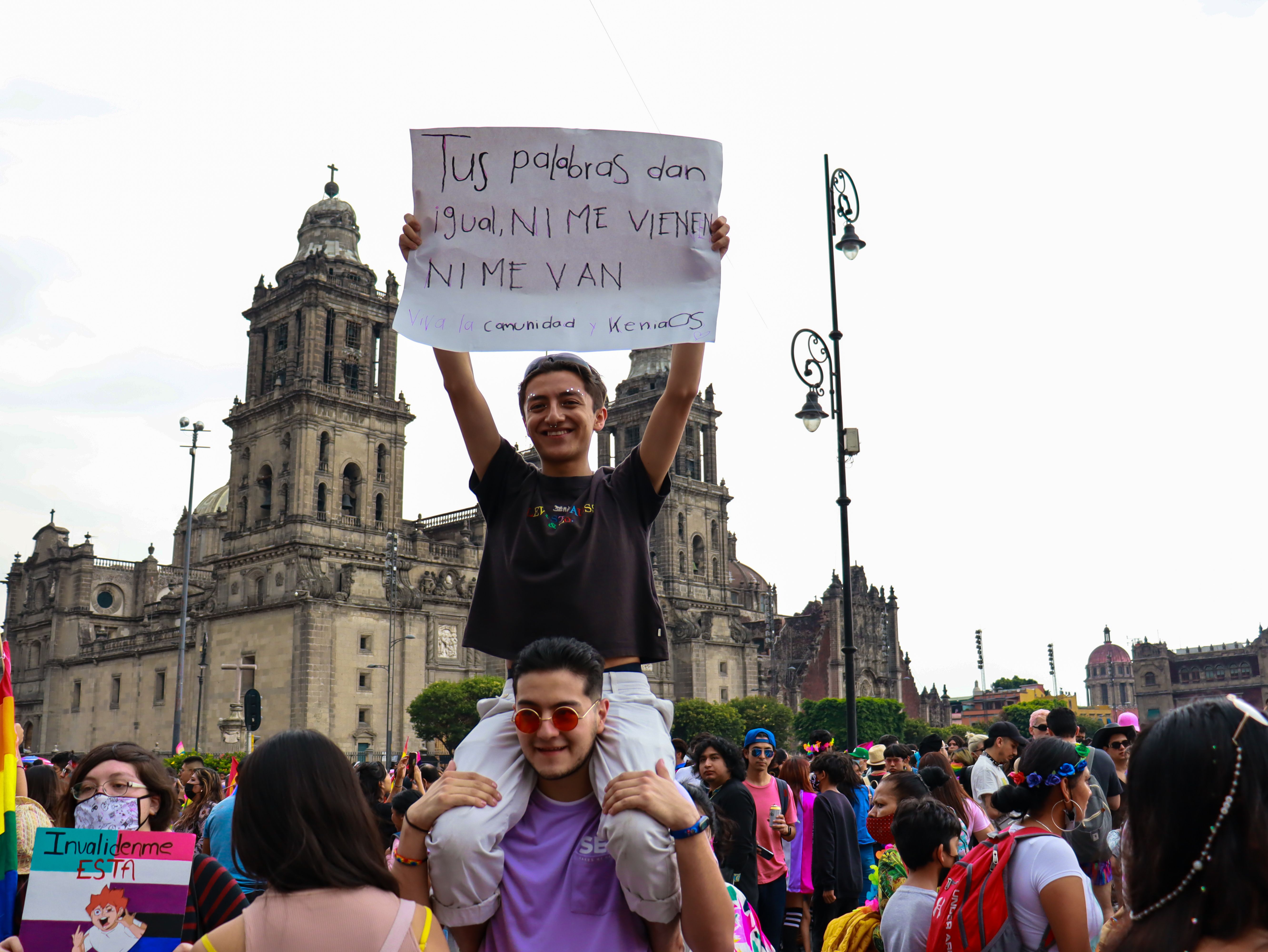 supporters crossing a crowded plaza near Mercedes-Benz Stadium in Atlanta, flags raised before an evening match