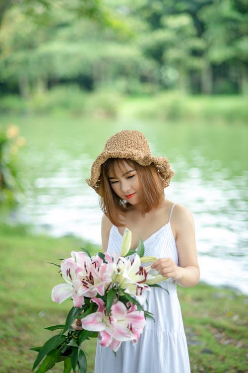 Free Photo of Woman Holding Bouquet of Flowers. Stock Photo