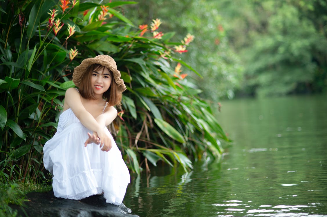 Woman Wearing White Dress Near Body of Water · Free Stock Photo
