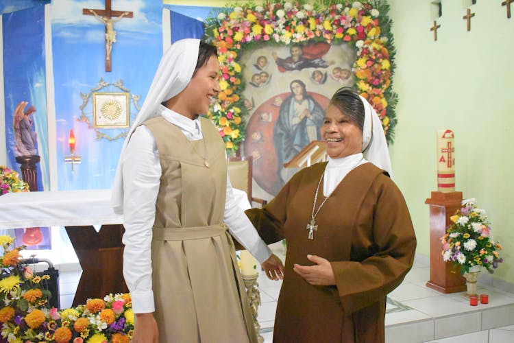 Smiling Nuns Standing At The Altar