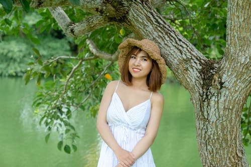 Woman Standing Beside Tree