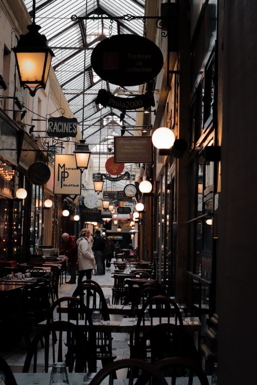 Free Cozy indoor view of Passage des Panoramas in Paris, capturing the vintage charm of this historic shopping arcade. Stock Photo