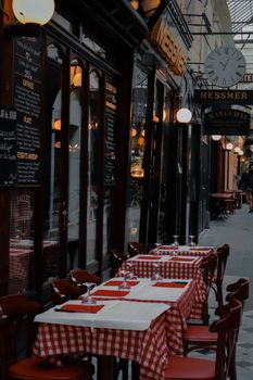 Charming outdoor cafe in Paris with checkered tablecloths, perfect for al fresco dining.