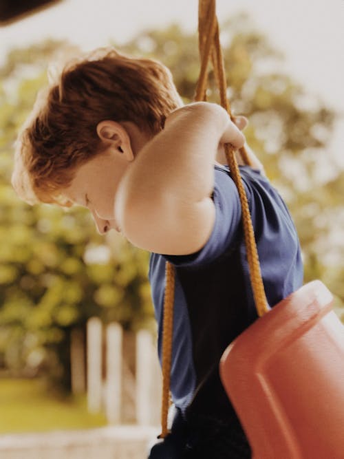 A Boy Sitting on a Swing