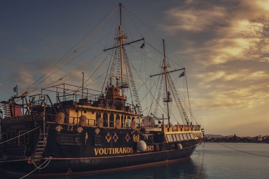 Captivating view of a vintage ship docked in Zakynthos, Greece, during sunset with a scenic sky.