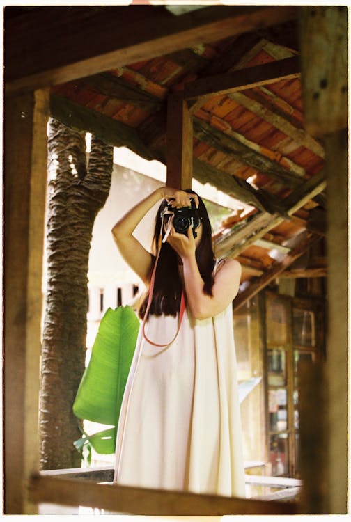 A Woman Taking a Photo Using a DSLR Camera