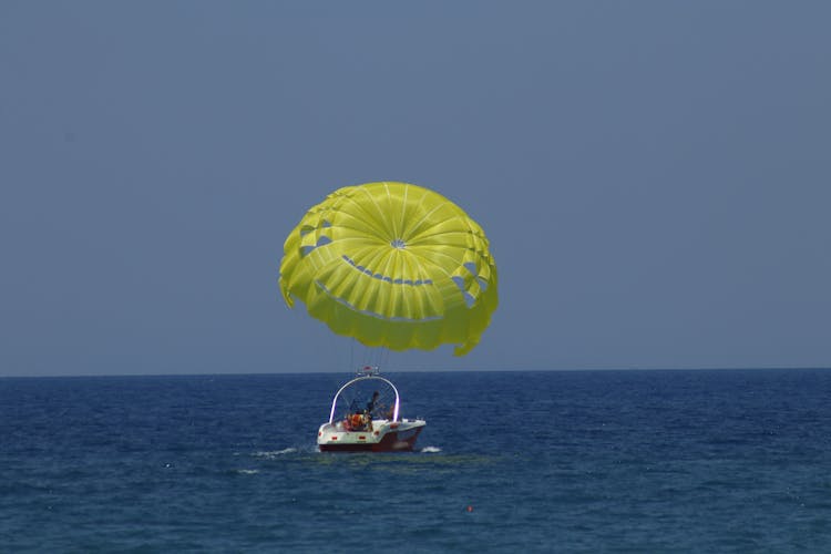 A Person Parasailing In The Ocean