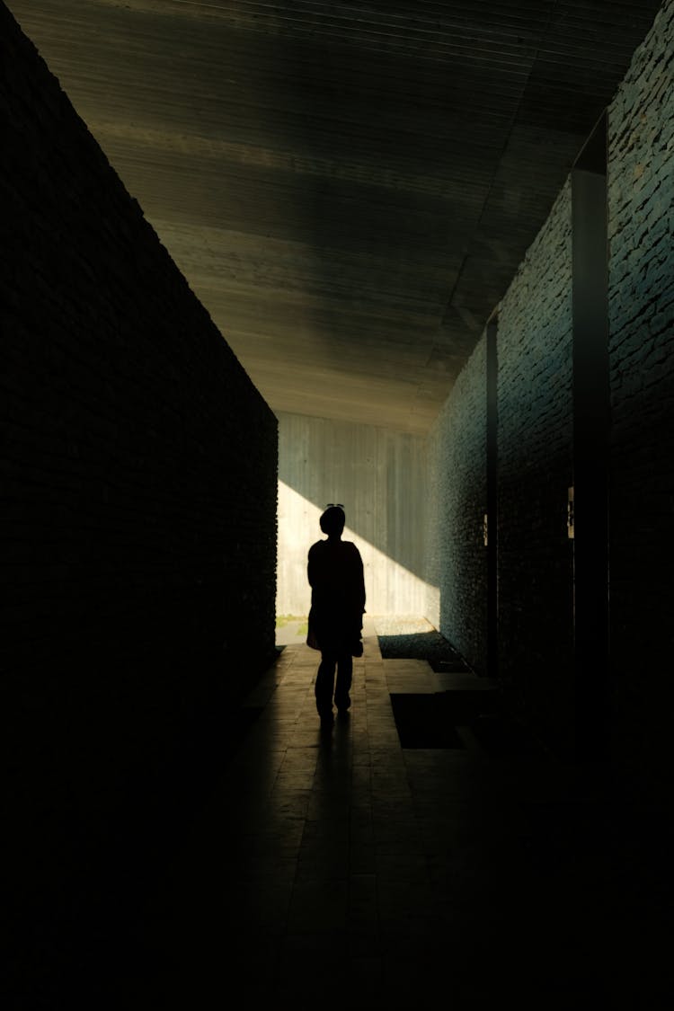 Silhouette Of A Person Walking On The Hallway