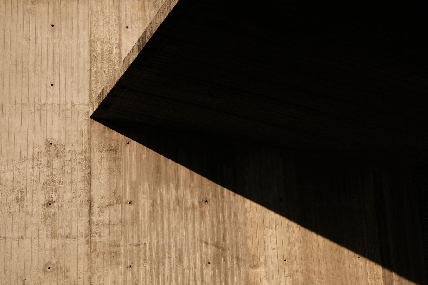 Abstract concrete wall with contrasting shadows and geometric forms