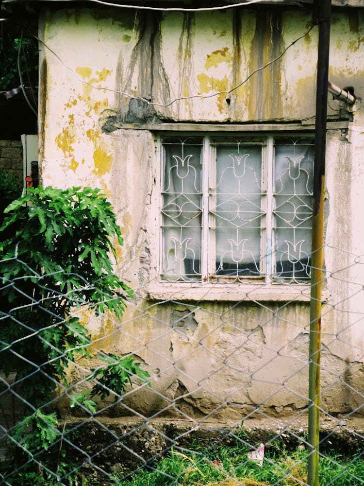 Abandoned House Behind Fence