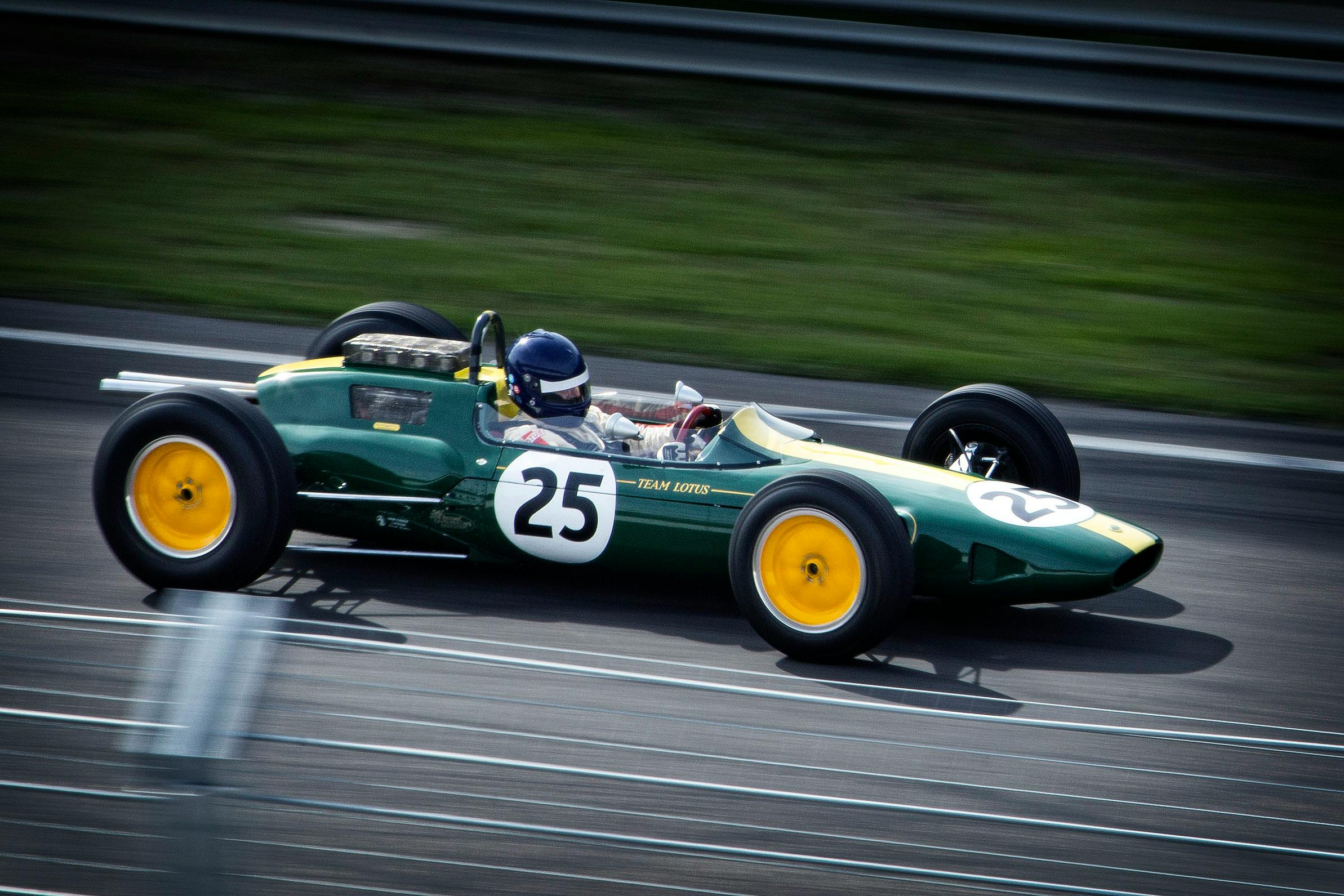 timelapse photography of green and white racing vehicle on lane