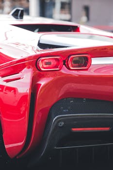 Detailed close-up view of a luxury sports car's red tail light showcasing its design.