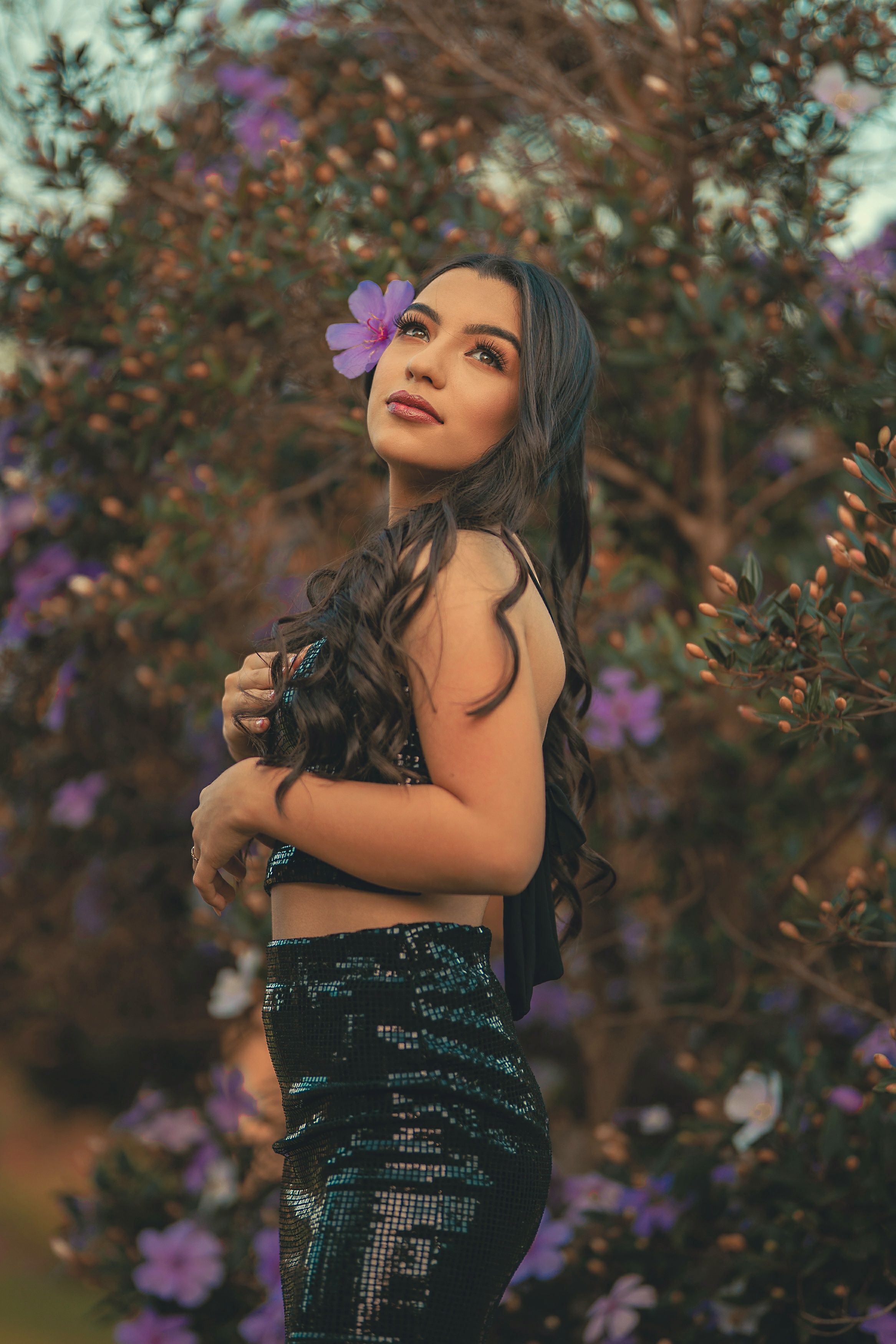 Portrait of a Pretty Brunette Wearing a Flower in Hair · Free Stock Photo