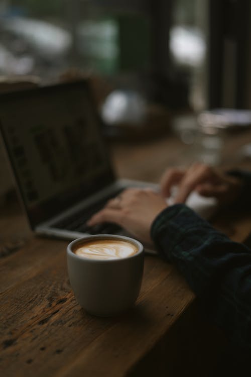 Free Cup of Coffee Beside a Laptop Stock Photo