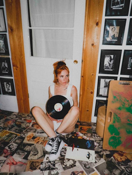 Woman in White Tank Top Holding a Vinyl Record