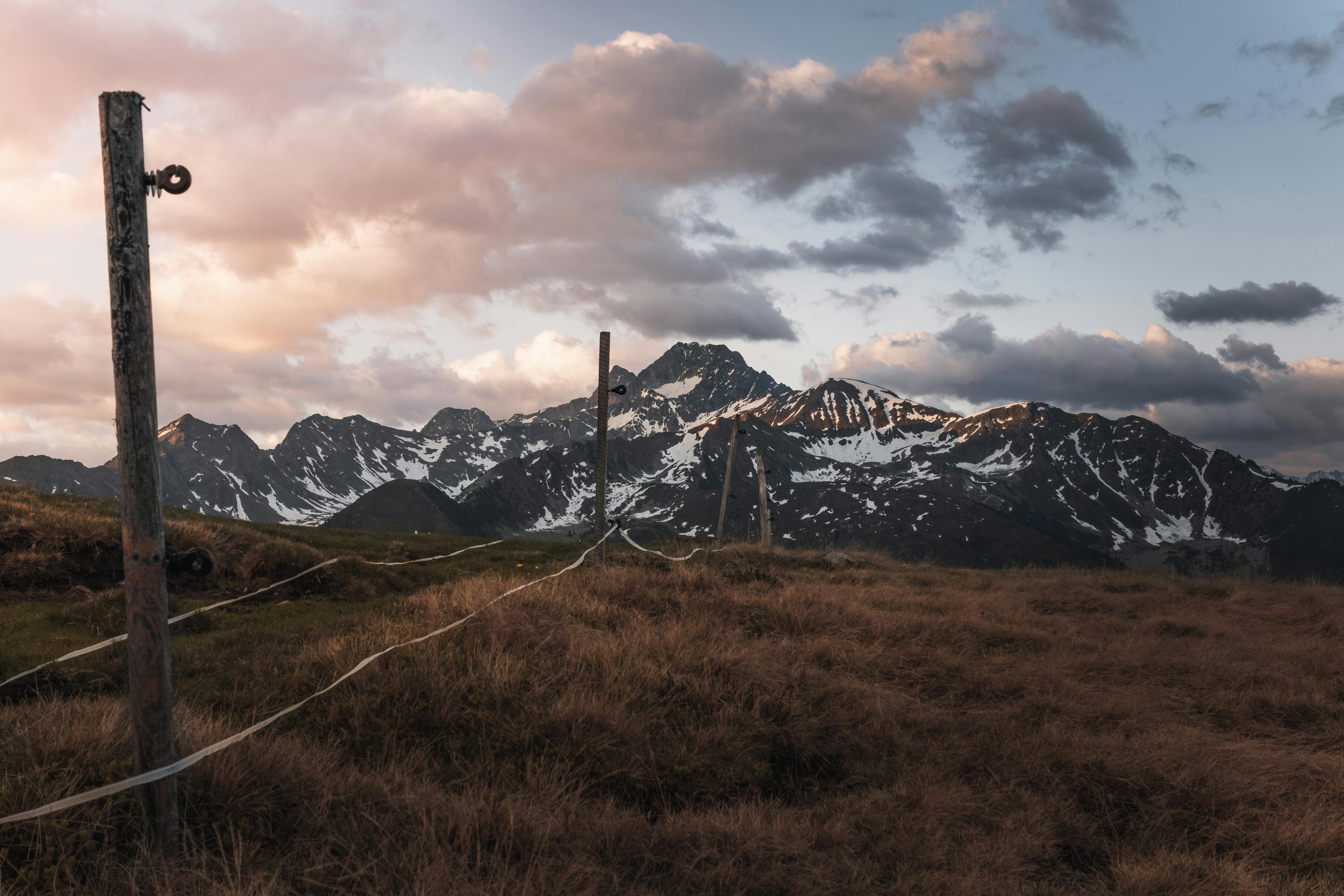 Explore the stunning mountain landscape in Tyrol, Austria with dramatic clouds at sunset.