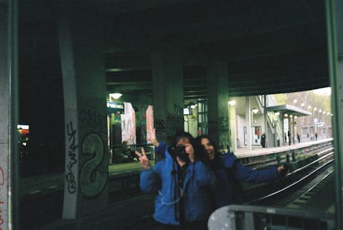 Woman Photographing by Railway Tracks