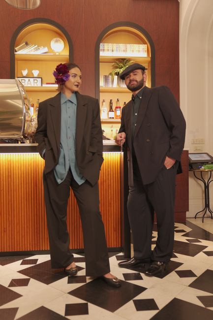 Elegant vintage fashion models posing indoors at a stylish bar, capturing a retro yet modern look.