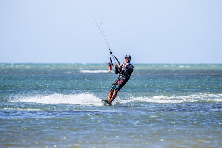 Man Windsurfing At Sea