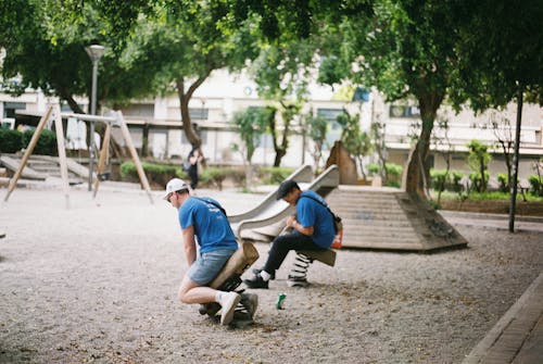 Men Playing on Children Playground