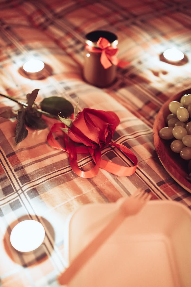 Red Rose And Candles On The Bed