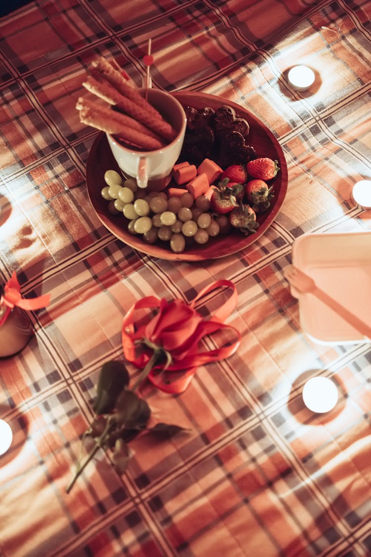 Rose And Snacks On Table