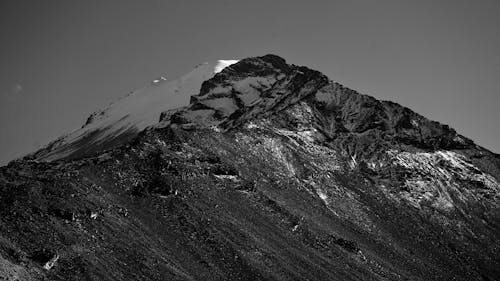 Grayscale Photo of Snow-Covered Mountain