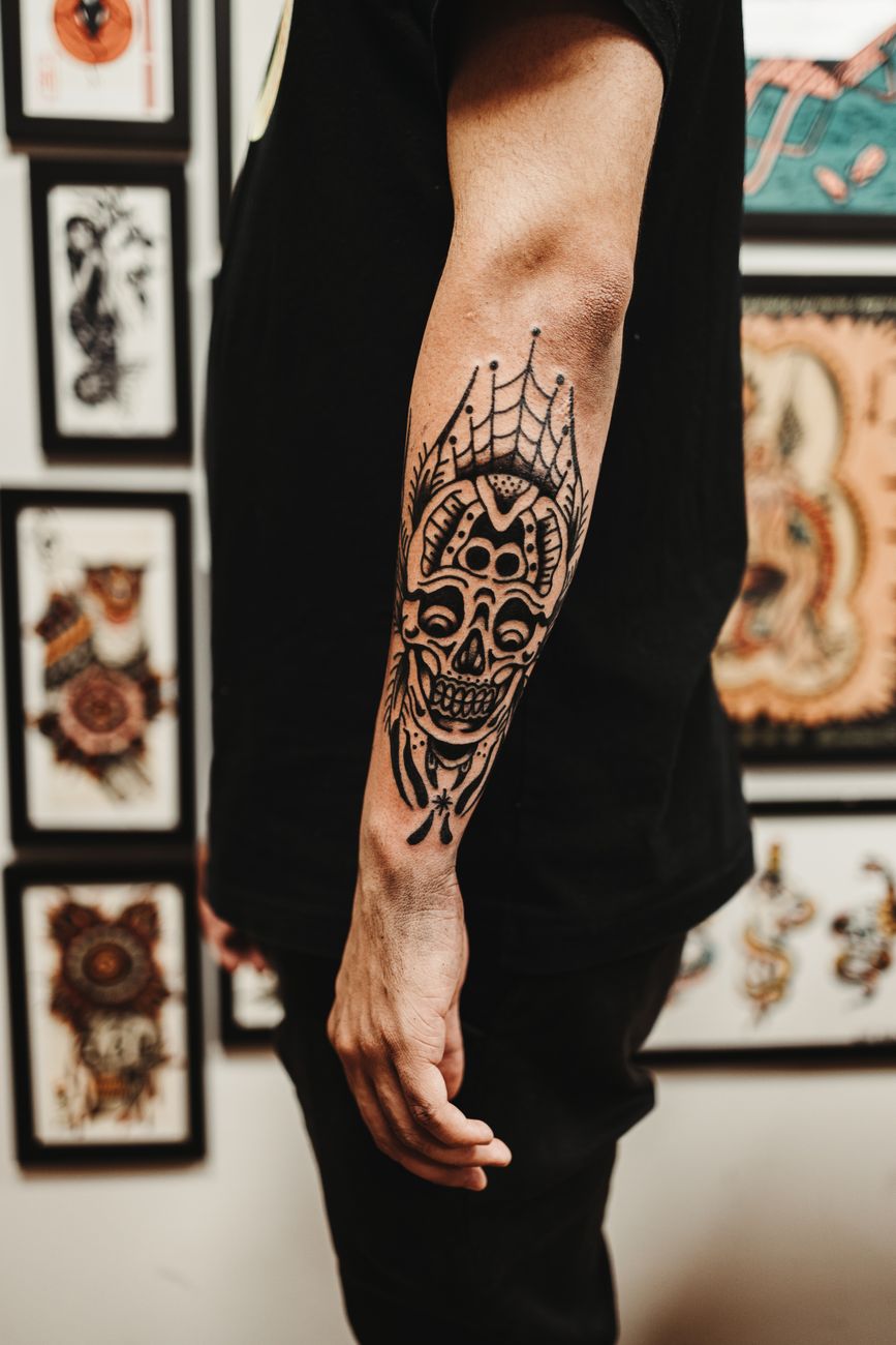 Detailed traditional tattoo work on a forearm at No Regrets Tattoo