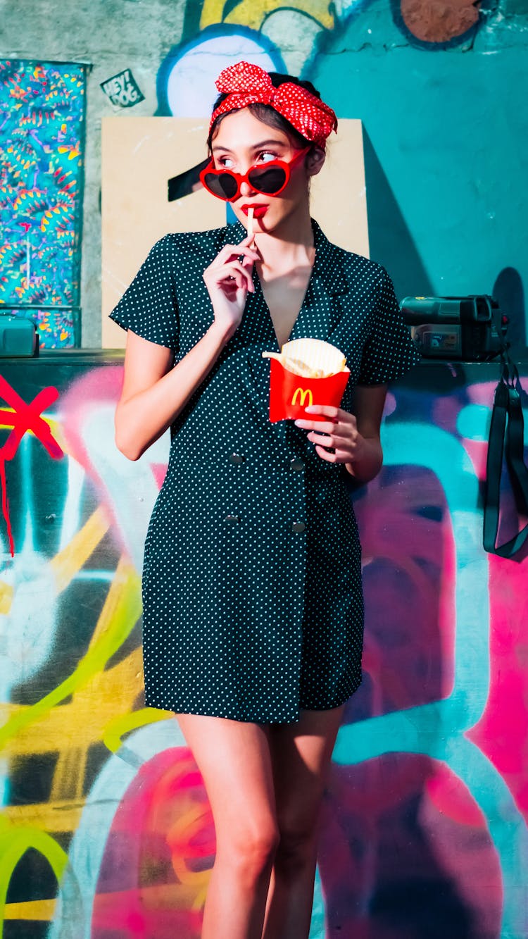 Woman In Black Dress Eating French Fries