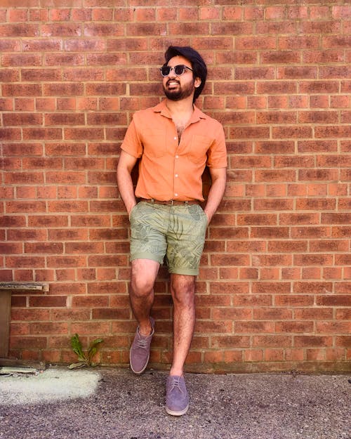 Man Leaning on a Brick Wall