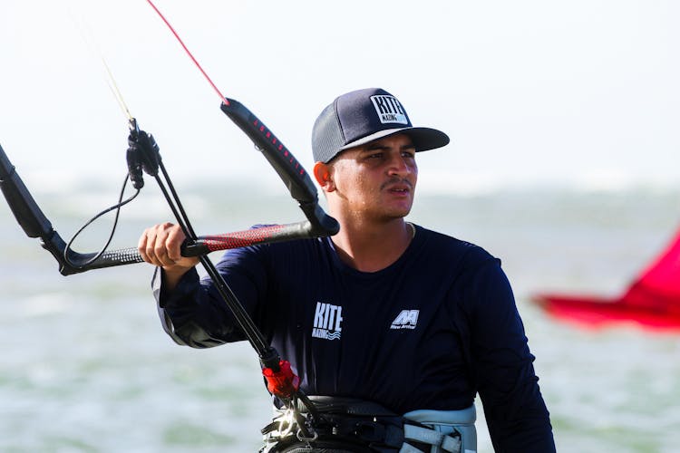 Man Wearing Cap And Sportswear Surfboarding